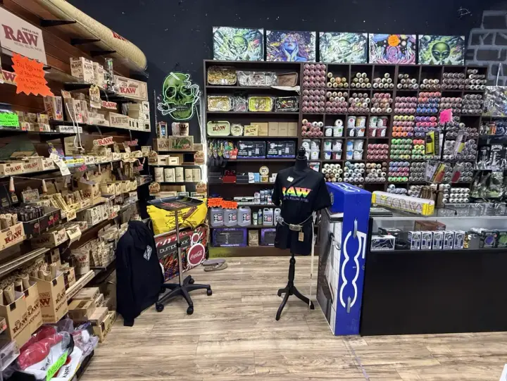 Kratom and herbal shelves along the wall at Smoker's Alley Gallery