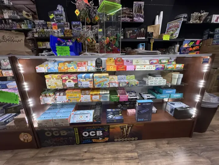 Lit glass counter stocked with rolling papers at Smoker's Alley Gallery, 13 Mile Rd, Roseville