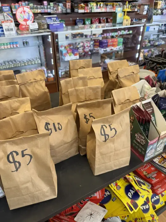 Five and ten dollar grab bags stacked on the counter at 29035 Gratiot