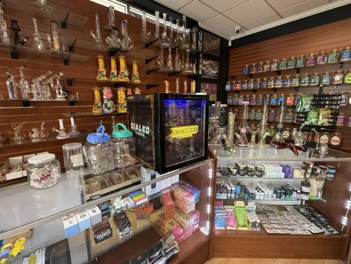Glass bongs and rigs along the wall shelf at Smoker's Alley, 29035 Gratiot Ave, Roseville