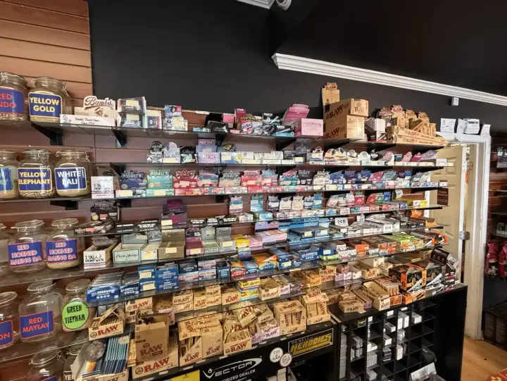 Wall of rolling papers, cones and wraps above the wood counter at Smoker's Alley, 29035 Gratiot Ave, Roseville